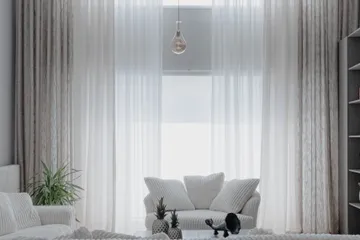 Bright, clean modern living room with soft white interiors