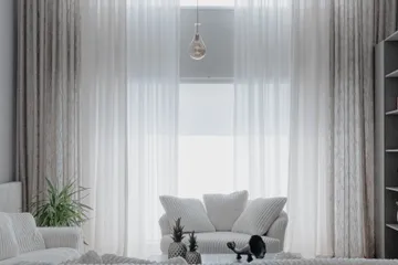 Bright, clean modern living room with soft white interiors